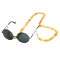 Detail of amber tortoiseshell acrylic eyewear chain attached to black round sunglasses - Amber Orange Yellow