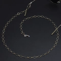 Fashionable gold glasses chain with diamond and round links on a textured black background - Gold