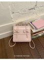 Detailed view of pink bow-knot backpack with brand logo on smooth synthetic leather - Pink