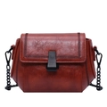 Vintage reddish-brown leather crossbody bag with woven stitching and black metal chain - Tan