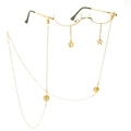 Gold metal frame glasses with star pendants and pearl chain decor on white background - Gold