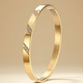Polished gold stainless steel bangle featuring diagonal pave zircon stones and side clasp - Gold Color Diagonal Inlay Style
