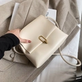 Minimalist beige crossbody bag featuring a golden metal ring clasp in a stylish square shape - White