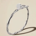 Detail of silver bamboo textured bangle with flat round clasp on polished metal - Steel Color Bamboo Nail Bangle (39-D-2)