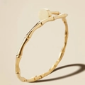 Detail of 18K gold stainless steel bracelet featuring a bamboo joint design and smooth disk - Gold Bamboo Nail Bangle (39-D-3)