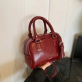 Deep red patent leather mini bowling bag with top handles and adjustable cross-body strap - Red