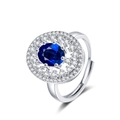 Luxurious silver open ring featuring an oval blue gemstone surrounded by white zircon pave - Adjustable Open / White Gold Color-Blue Zirconia