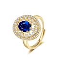 Luxury gold open ring featuring a large oval blue sapphire stone with double halo diamonds - Adjustable Open / Gold Color - Blue Zirconia