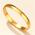 Detail of 8mm gold polished stainless steel bangle showing hinge closure and mirror finish - 8mm Width Domed / Gold
