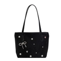 Black tote bag with white pearl accents and silver rhinestone bow charm on white background - Black