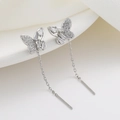 Elegant silver butterfly tassel earrings with shimmering crystals on minimalist background - White Gold