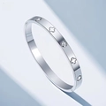 Elegant silver steel bangle with clover cut-outs and inlaid round sparkling crystals - Steel Clover Engraved Style