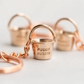 Macro view of rose gold bucket keychain with polished finish and FUCKIT BUCKET engraving - Bucket + Keychain / Rose Gold