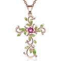 Rose gold cross necklace featuring pink gemstone and green enamel leaves on white background - Rose Gold