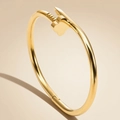 Modern gold-plated stainless steel nail bangle featuring a clover motif and polished finish - Gold Clover Nail Style (40-B-3)