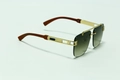 Detail of square rimless sunglasses with gold metal frame and brown wood grain temples - Gold Frame Tea Grey Lens