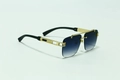 Detailed close-up of golden metal frame with elegant hollow carving on blue gradient sunglasses - Gold Frame Double Grey Lens