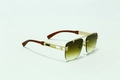 Close-up of wood grain temples and metal hinges on vintage square rimless sunglasses - Gold Tea Gradient