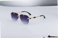 Detailed close-up of engraved gold metal temples on rimless gradient purple sunglasses - C2 Gold Gradient Grey