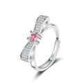 Detailed view of silver bow-knot ring with a pink round center stone and pave setting - Adjustable Open / Bowknot Ring