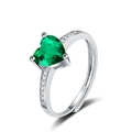 Detailed view of heart-shaped green gemstone ring with side zircons and adjustable band - Adjustable Open / Green Zirconia