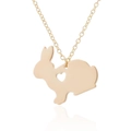 Macro shot of golden rabbit pendant with heart-shaped cutout on minimalist necklace - Gold