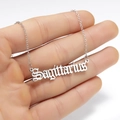 Macro shot of silver Sagittarius pendant in gothic font on a fine silver link chain - Sagittarius Steel
