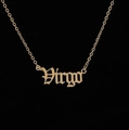 Detailed macro view of the gold Virgo zodiac pendant with a gothic font design - Virgo Gold