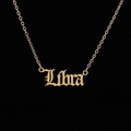 Macro detail of gold-plated stainless steel necklace with Libra zodiac gothic pendant - Libra Gold