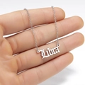 Macro detail of Libra zodiac pendant in Gothic font on a polished silver chain - Libra Silver Tone