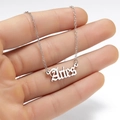 Detailed close-up of a silver Aries zodiac necklace with gothic font lettering - Aries Steel