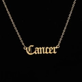 Close-up of gold gothic Cancer necklace with a delicate cable chain on black background - Cancer Gold