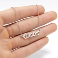 Close-up of silver Gothic 'Cancer' zodiac letter pendant on a polished curb chain - Cancer Silver Tone