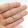 Detailed close-up of a silver Leo nameplate necklace featuring gothic font and fine chain - Leo Steel