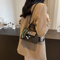 Classic black mini Kelly style bag in matte leather finish with green woven charm - Black