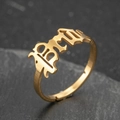 Adjustable gold stainless steel ring with gothic BM cutout design on black rock background - BM Style (056) / Gold