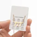 Detailed view of gold 777 angel number pendant necklace with meaning display card - Gold (777)