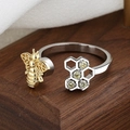 Luxurious honeycomb open ring with gold bee design and yellow gemstones on wood stand - Bee & 4-Zirconia Honeycomb Style (Rotating Honeycomb)