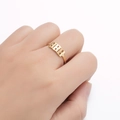 Golden stainless steel open ring featuring cutout number 888 on a female finger - Style 888 / Gold