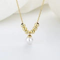 Elegante collana minimalista con pendente di perla bianca tonda e piccole perle dorate - Oro