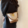 Chic canvas bucket bag with brown leather trim and golden twist lock closure - Brown