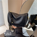 Black quilted crossbody bag with stylish geometric woven wide shoulder strap - Black