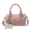 Pink Boston style handbag with adjustable strap and decorative plush charm in front view - Without Pendant / Pink