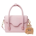 Pink stone pattern shoulder bag with curved handle and plush monster charm on white background - Pink