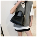 Detail of soft black lychee texture PU tote bag with gold metal hardware and slim strap - Black