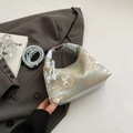 Light blue floral brocade dumpling bag with traditional Chinese embroidery and strap - Blue