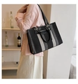 Detail of striped woven tote bag featuring dual leather handles and large capacity - Large / Black