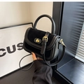 Retro black crossbody bag in suede and smooth leather with golden twist lock - Black