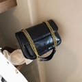 Black glossy V-quilted shoulder bag with a bold gold chain strap in urban style - Black