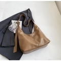 Minimalist brown faux leather hobo bag with adjustable strap on a grey blazer - Khaki